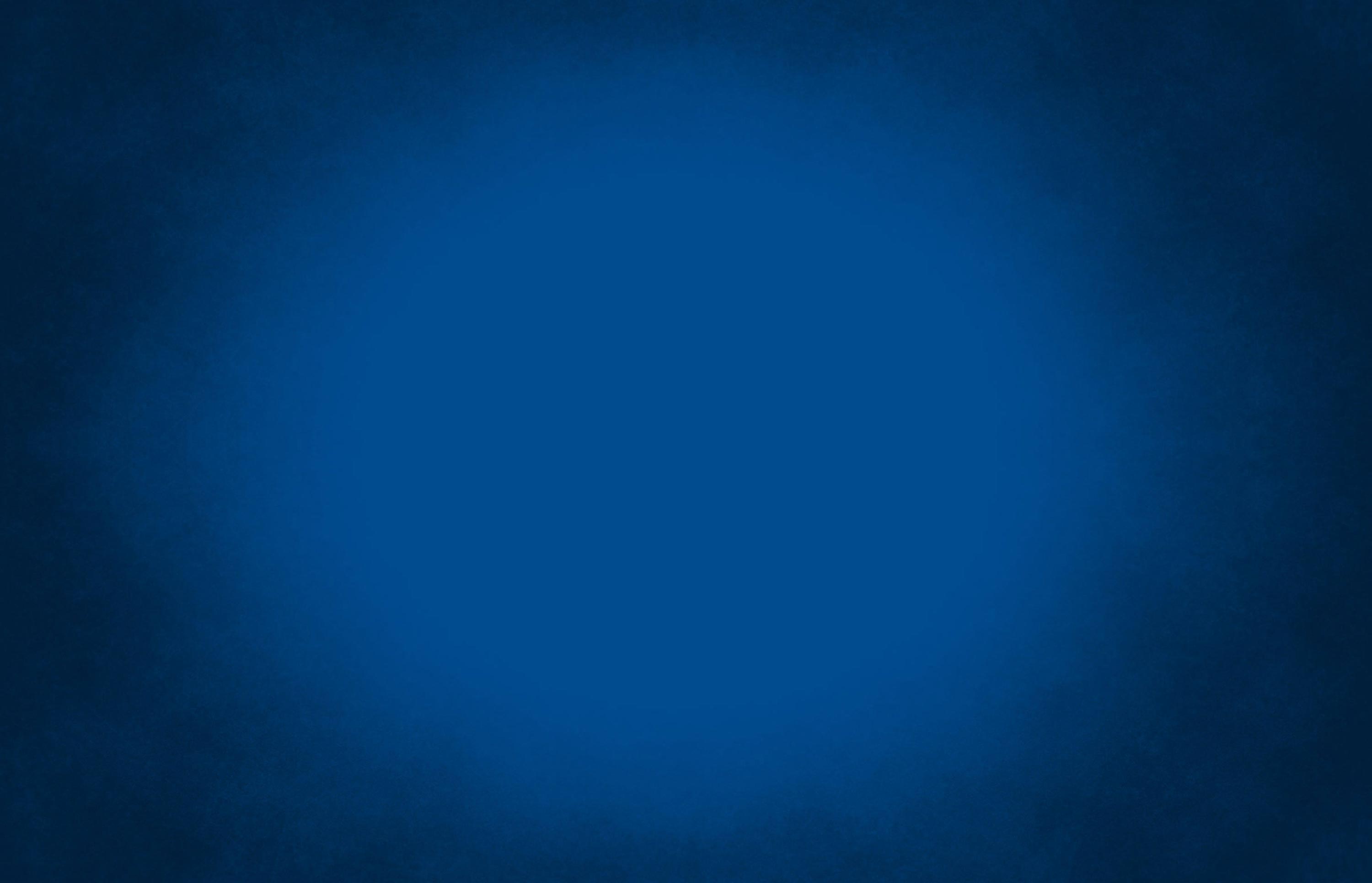 Plain abstract background with dark blue vignette and lighter blue glowing center